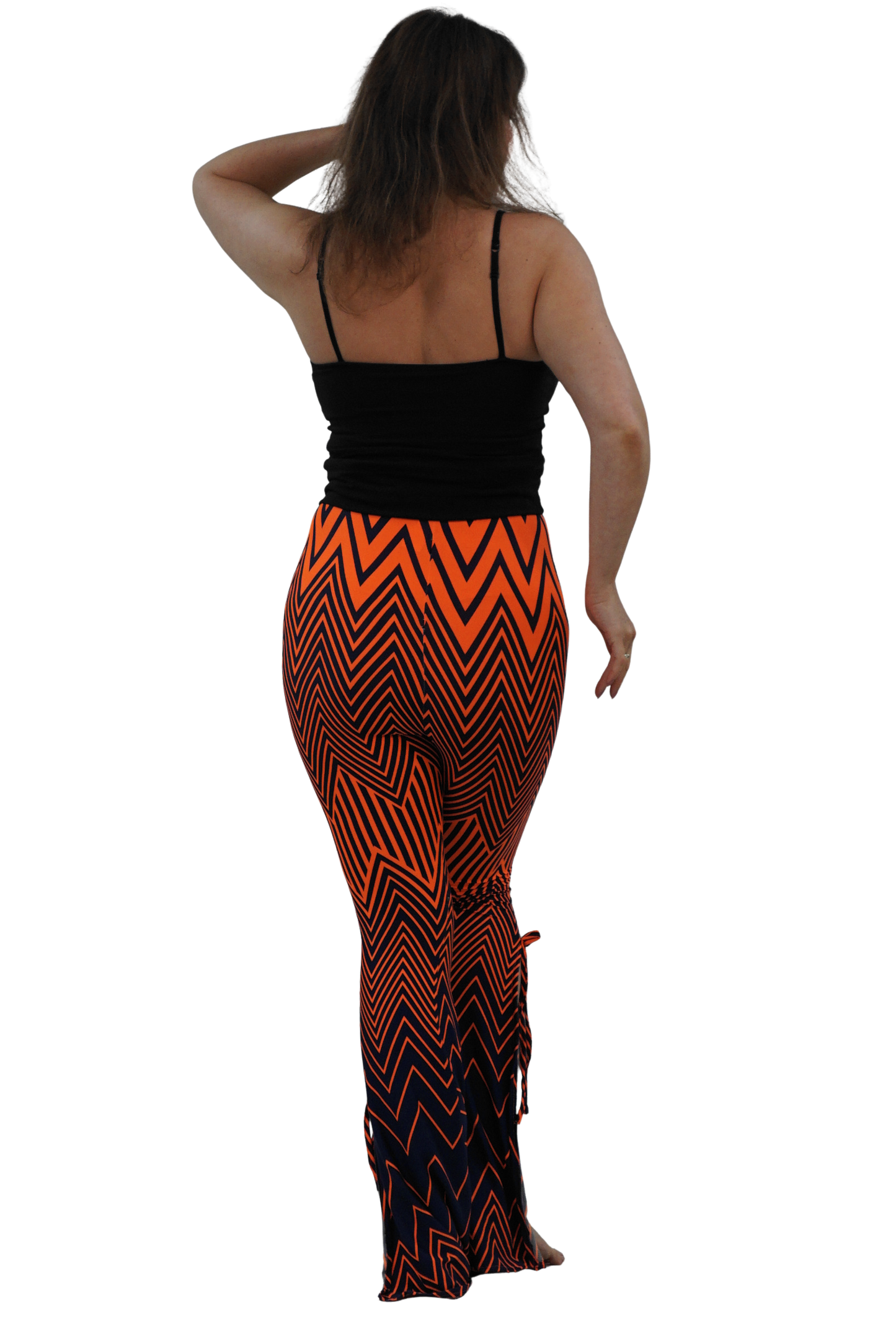A woman shown from the back wearing a black spaghetti-strap top and high-waisted, flared leggings with a bold orange and black chevron pattern, set against a solid white background.