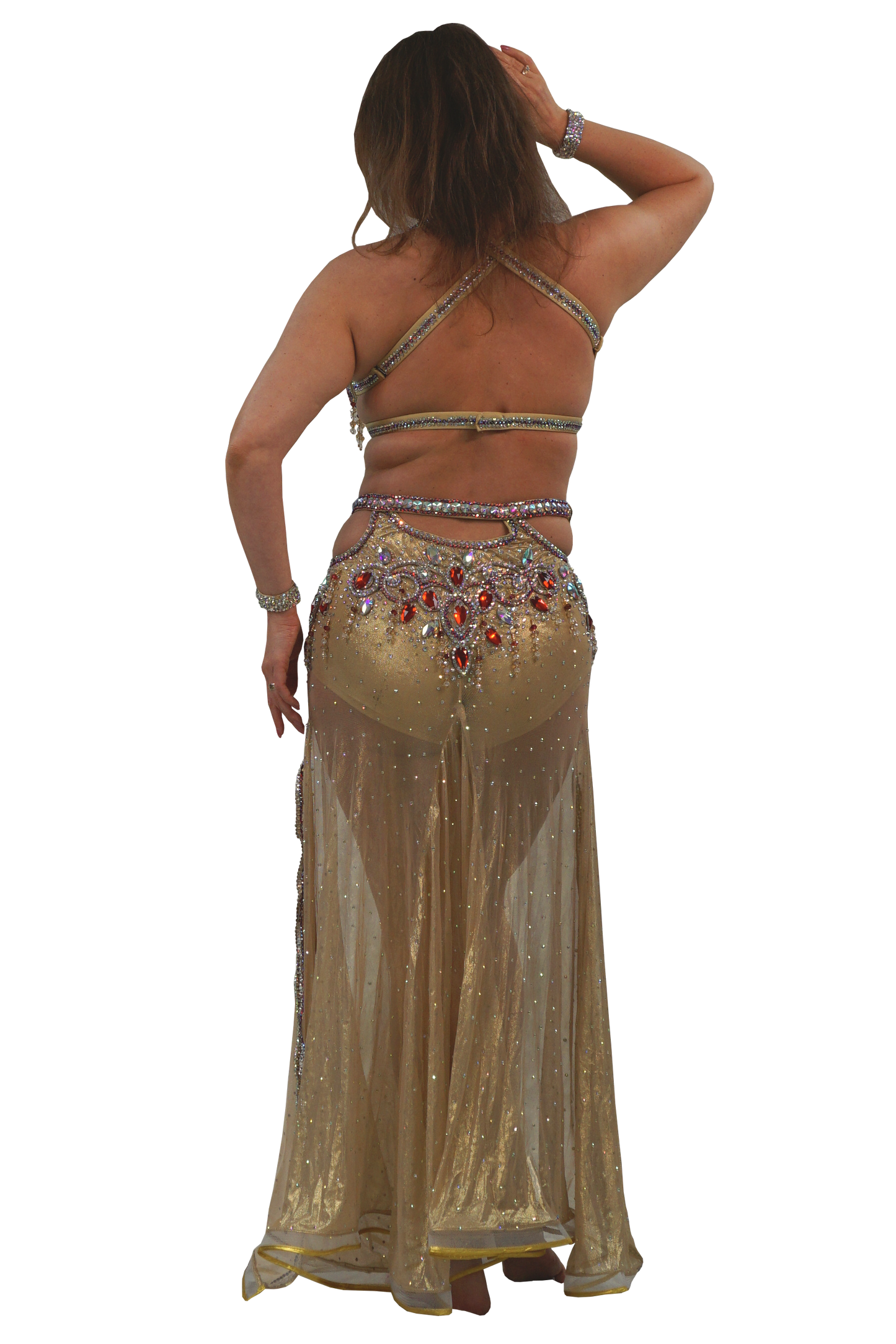 Woman wearing a gold belly dancing costume with intricate designs on a white background