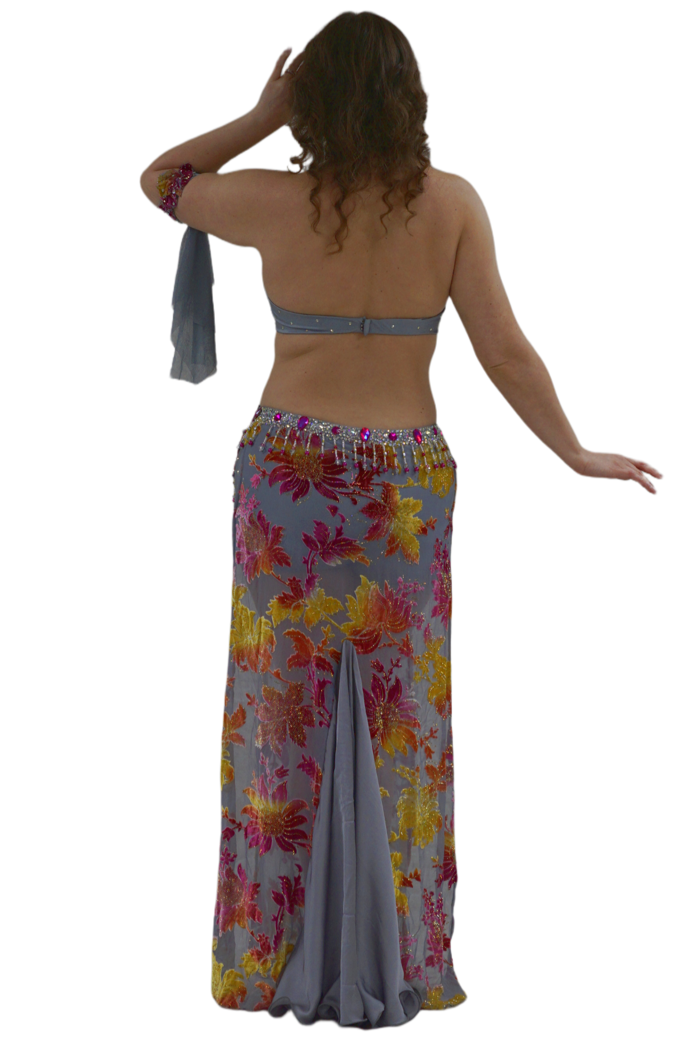Woman wearing a floral skirt and top on a white background