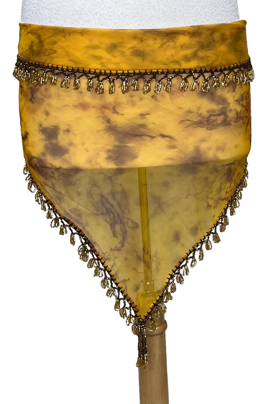 A yellow and brown marbled sheer mesh hip scarf with gold beaded fringe trim, displayed on a white mannequin torso.
