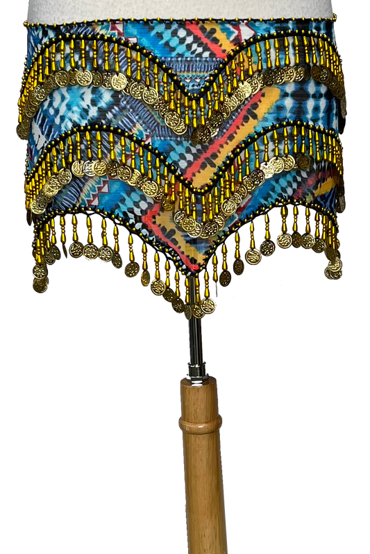 Colorful belly dance skirt with gold beads and a wooden stick on a white background