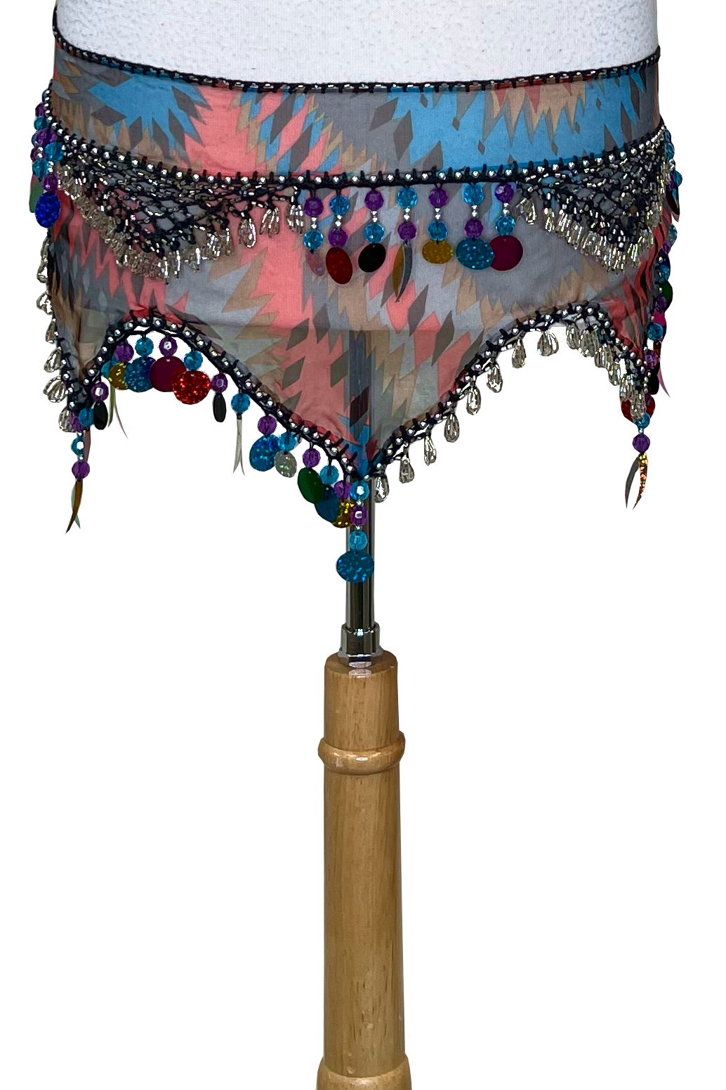 A colorful patterned belly dance hip scarf with silver and multicolor beads, sequins, and fringe, displayed on a mannequin torso against a white background.