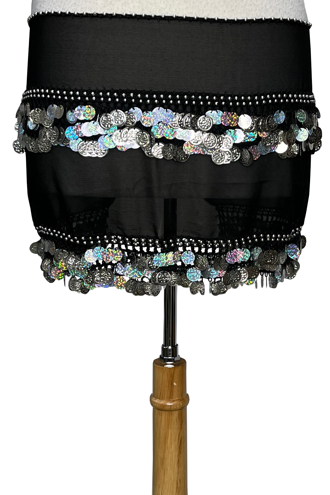 A black sheer hip scarf with silver coin embellishments and holographic sequins, displayed on a dress form against a white background.