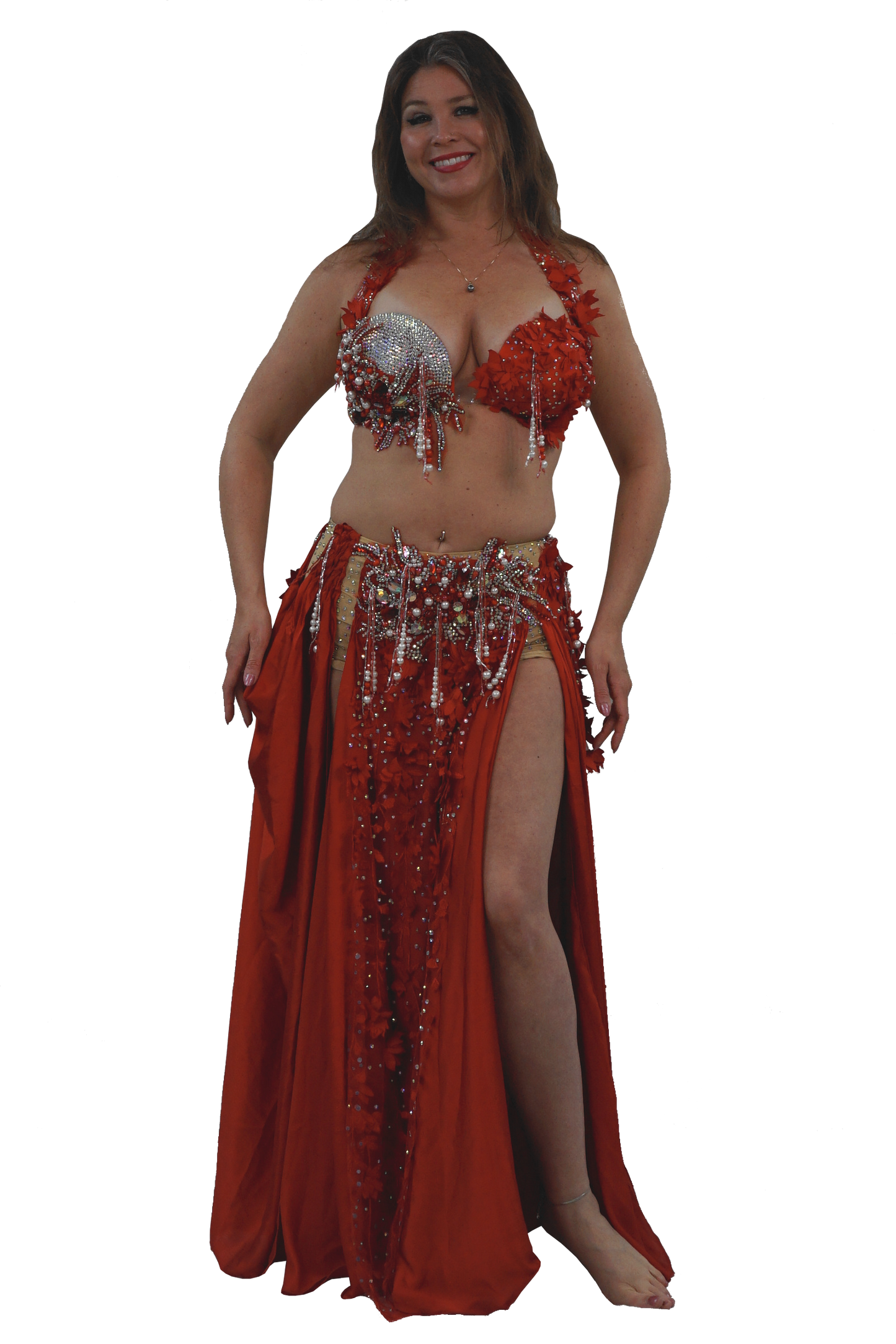 Woman wearing a red belly dancing costume with sequins on a white background