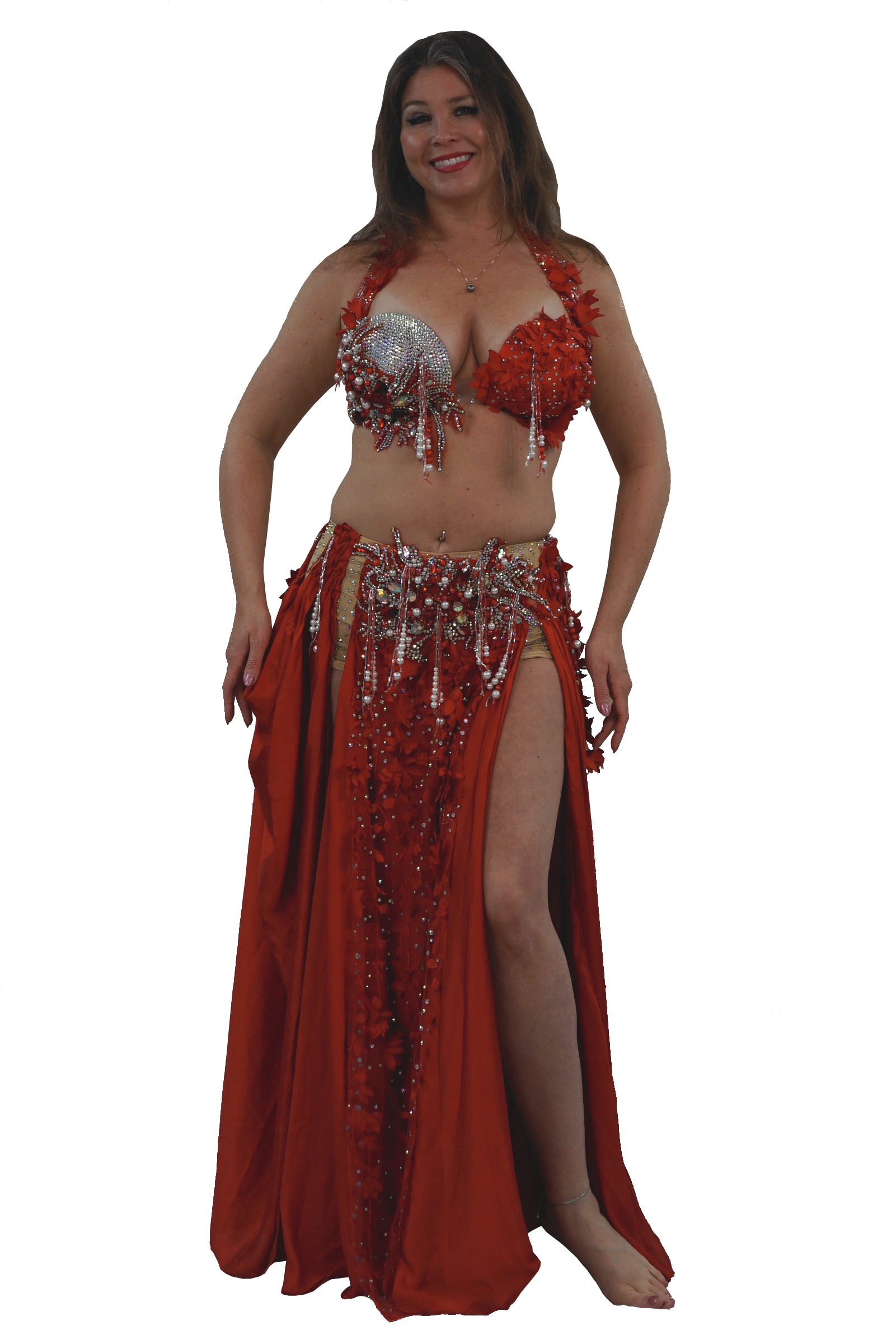 Woman wearing a red belly dancing costume with sequins on a white background