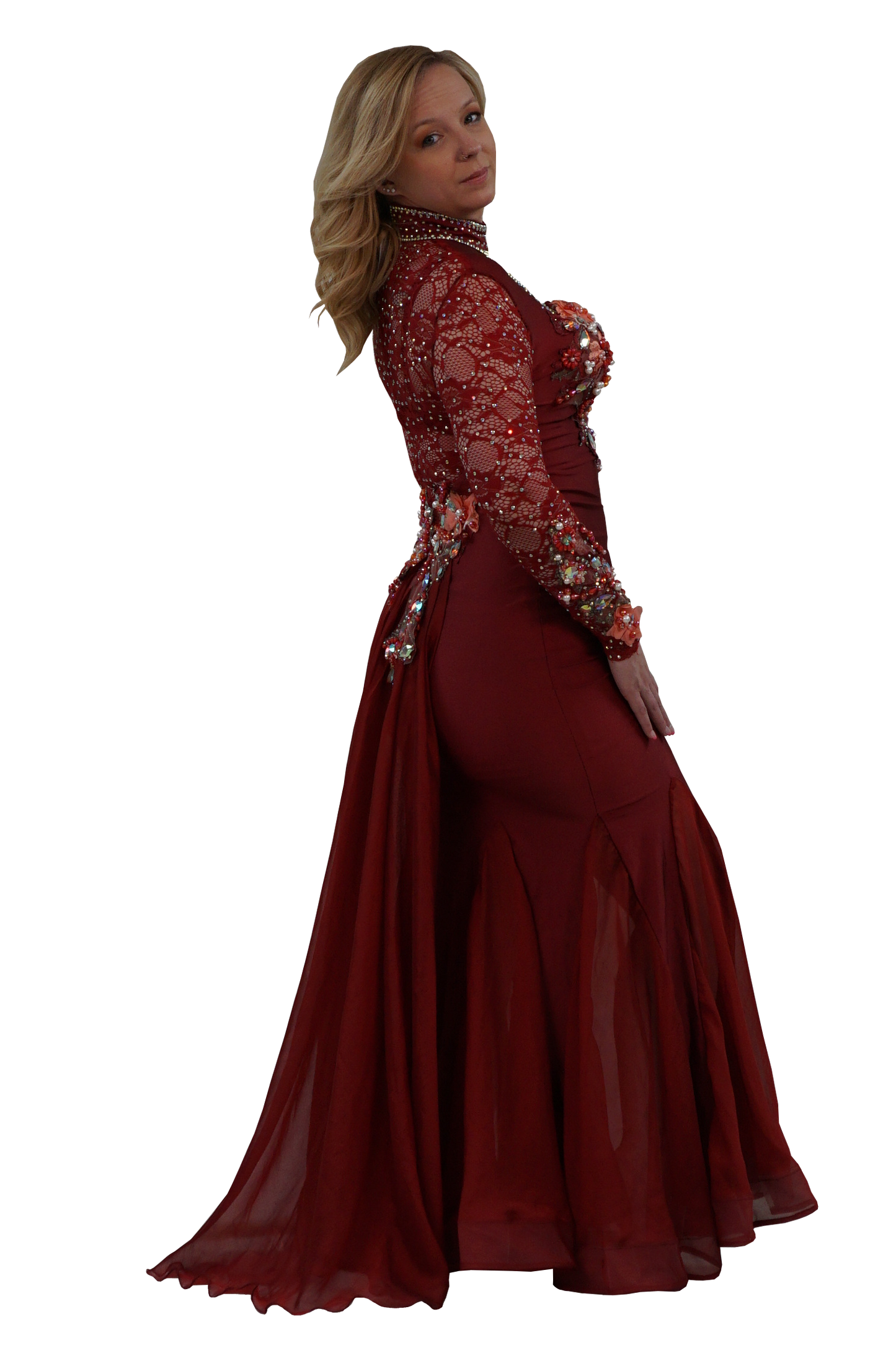 A woman modeling a floor-length burgundy mermaid gown with long sheer lace sleeves, floral work, and a high beaded neckline, shown against a plain white background.