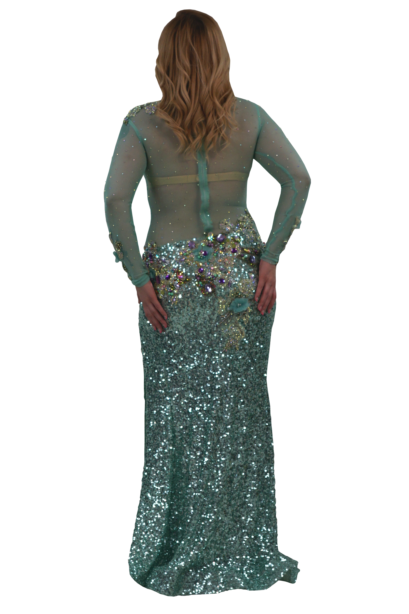 A woman modeling a floor-length teal sequined gown from the back, featuring sheer long sleeves, a structured back with a central strap, and a heavily embellished waistband with iridescent sequins and rhinestones, set against a plain white background.