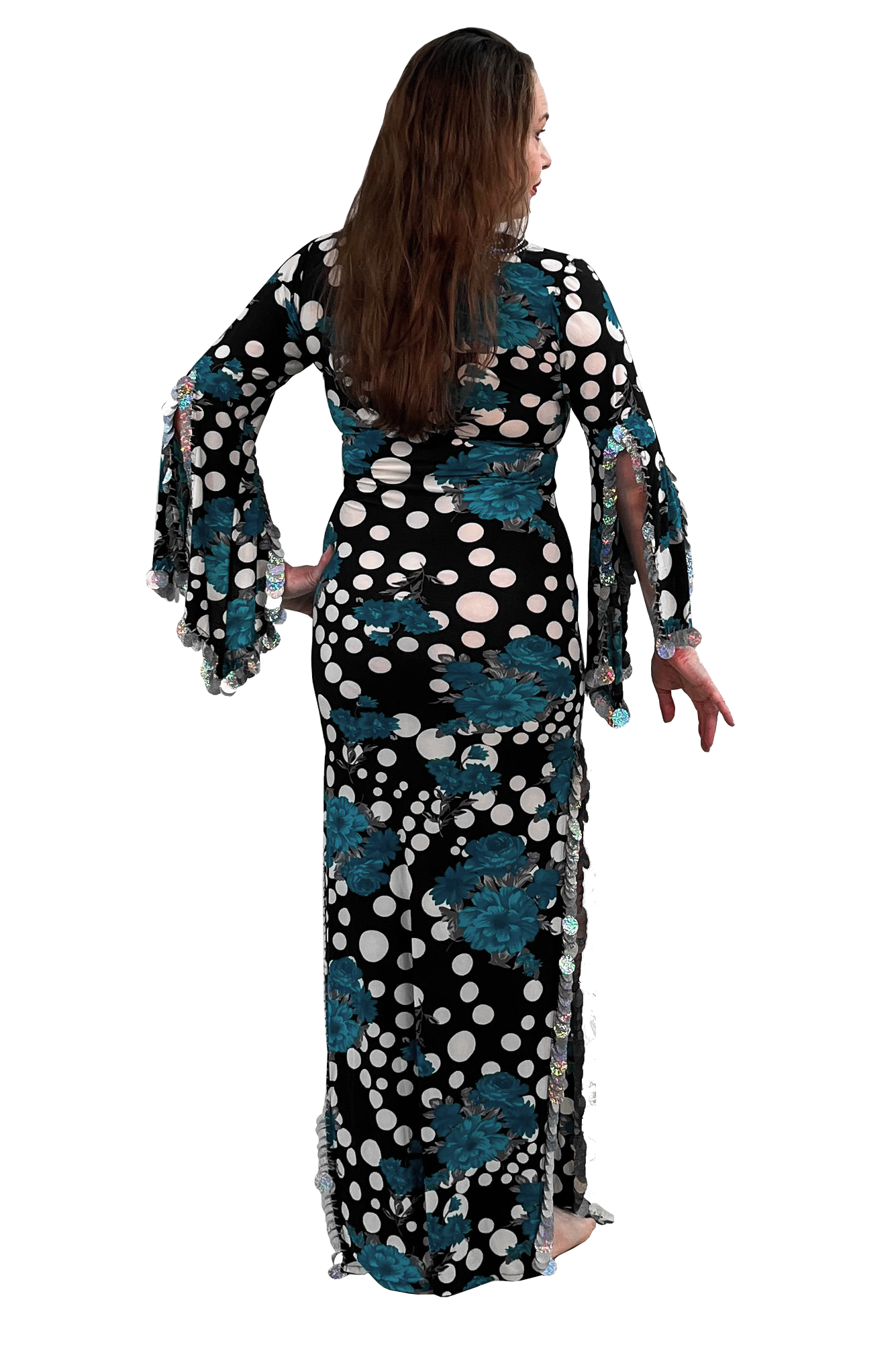 A woman modeling a long black maxi dress with teal floral patterns and white polka dots, shown from the back against a plain white background.