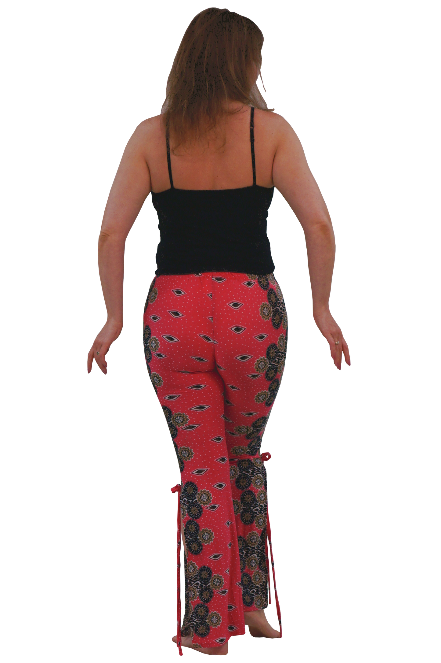 A woman shown from behind wearing pink patterned flared pants with black and dark brown paisley-style motifs, a black camisole top, and bare feet against a plain white background.