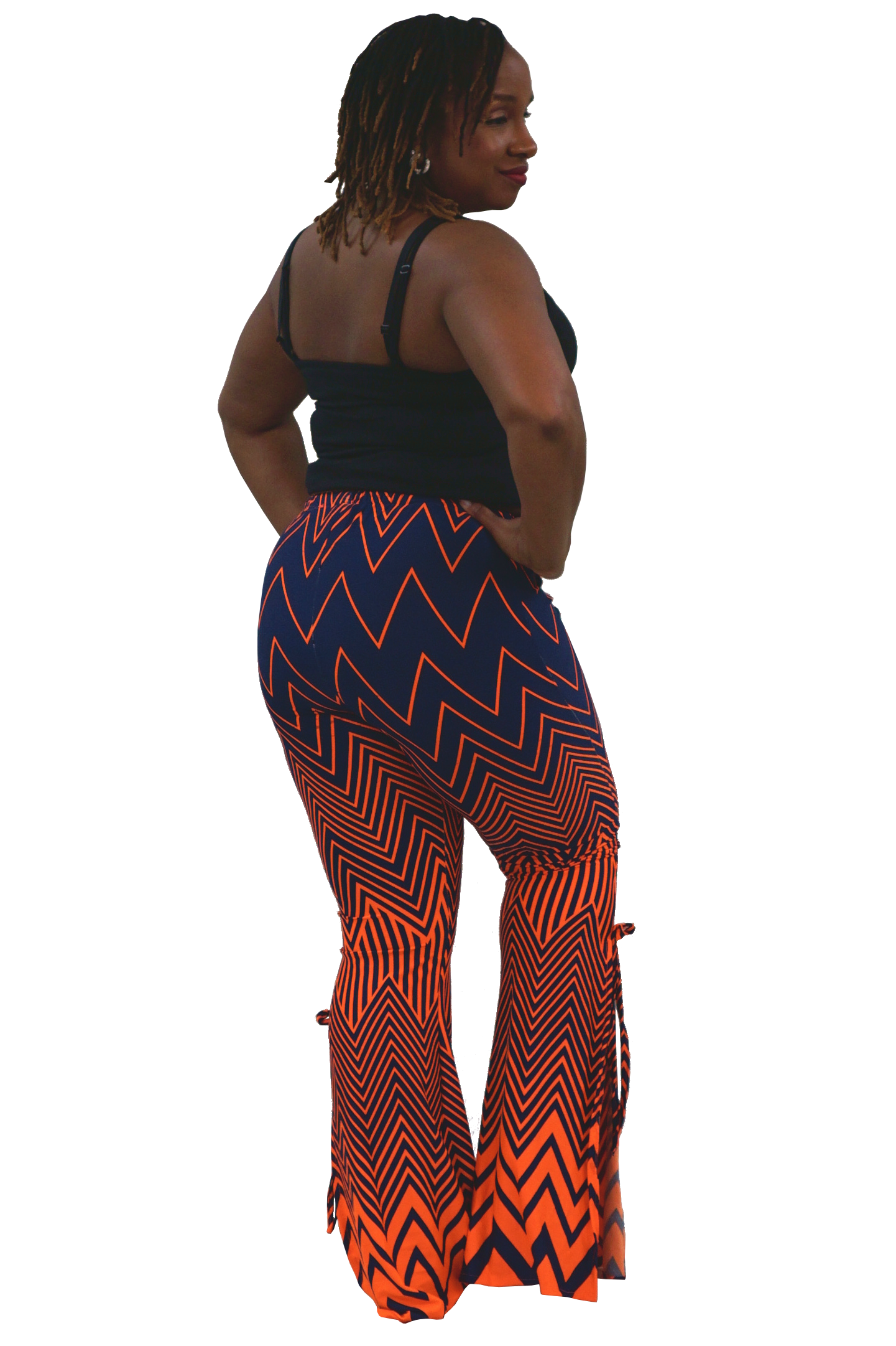 A woman shown from the back wearing a black camisole top and high-waisted, wide-leg flare pants with a bold orange and navy blue chevron pattern, set against a plain white background.
