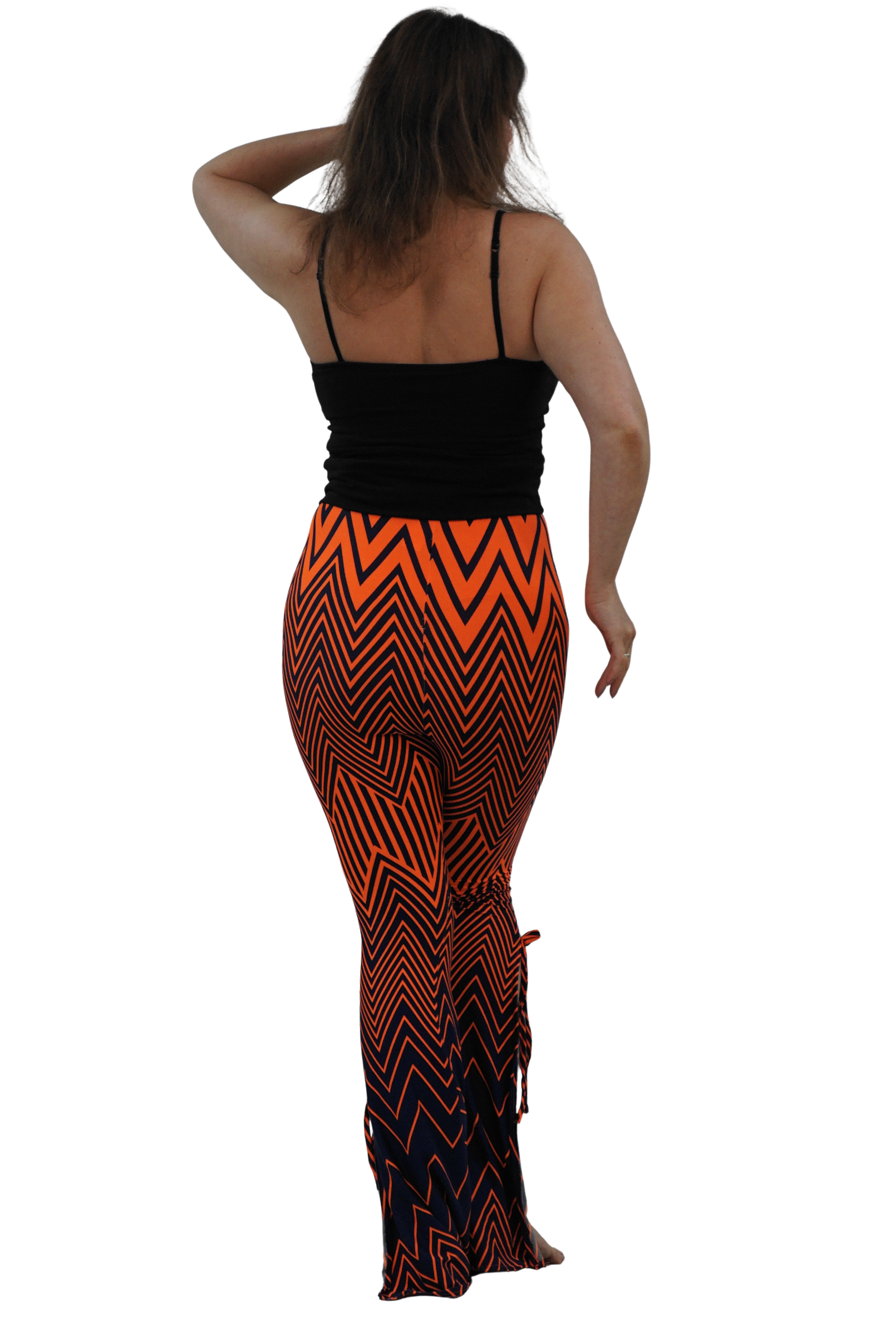 A woman shown from the back wearing a black spaghetti-strap top and high-waisted, flared leggings with a bold orange and black chevron pattern, set against a solid white background.