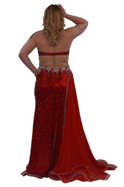 A woman shown from the back wearing a red embellished belly dance dress with a matching red and silver beaded waist belt, set against a plain white background.