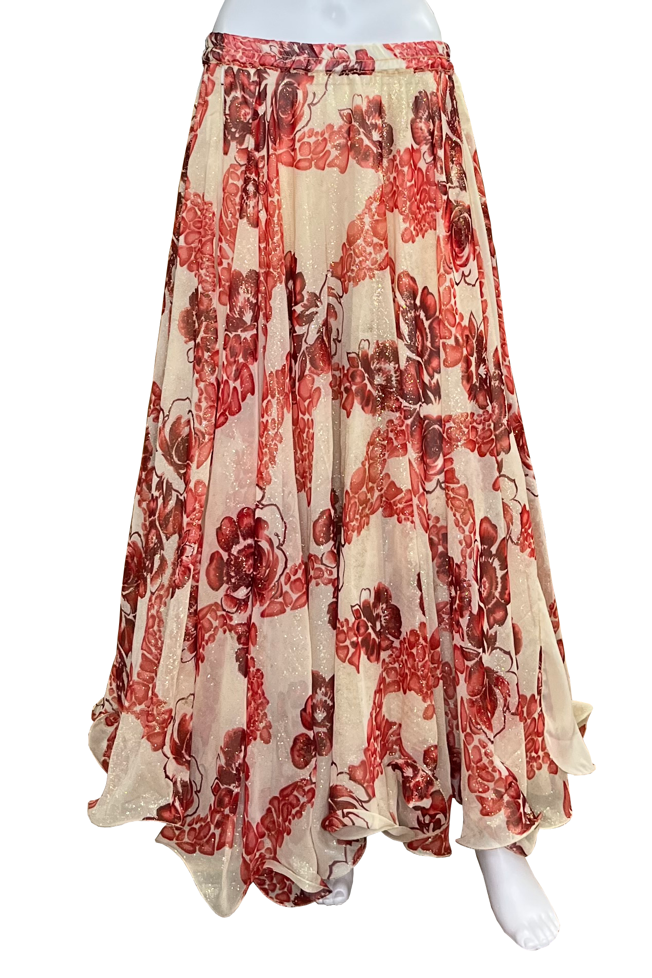 A flowing maxi skirt with a red and brown floral pattern on a glittery beige base, displayed on a white mannequin against a white background.