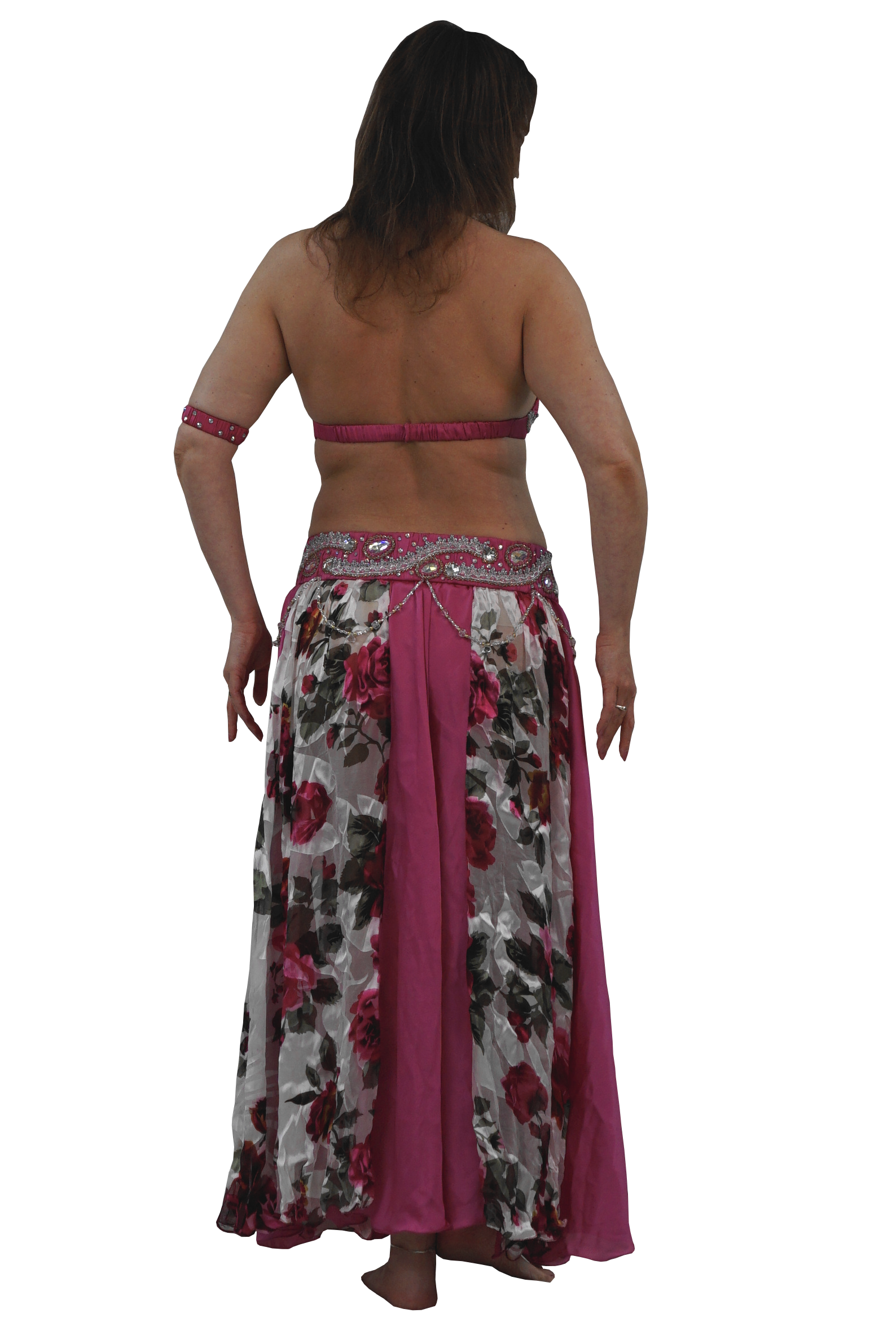 A woman shown from the back wearing a belly dancing costume consisting of a floral print skirt with a solid magenta lining and a matching magenta halter top with a matching armband, set against a plain white background.
