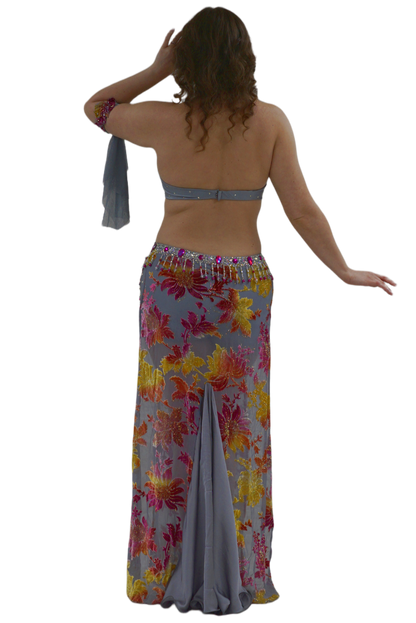 Woman wearing a floral skirt and top on a white background