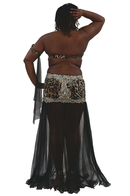 A woman shown from the back wearing a belly dance costume with a leopard-print and zebra-print waist scarf embellished with rhinestones, a matching strapless top, and a long black sheer skirt.