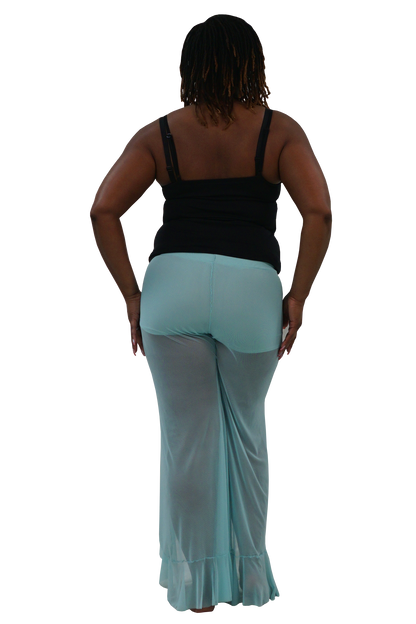 A woman shown from the back wearing a black tank top and light aqua sheer flared pants against a plain white background.