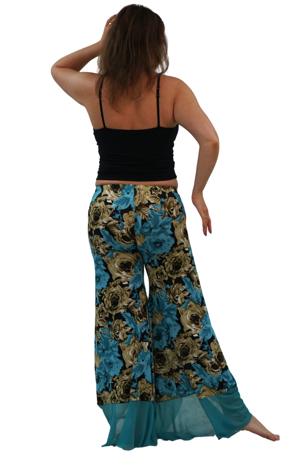 A woman shown from the back wearing wide-leg bohemian-style pants with a blue, gold, and black floral pattern, paired with a black camisole, against a plain white background.