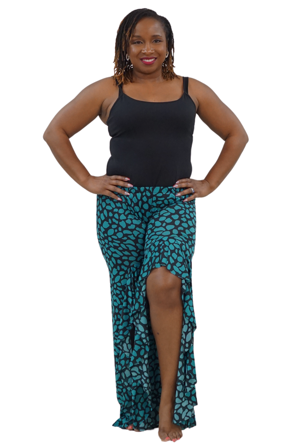 A woman modeling a black sleeveless tank top and a high-low teal and black patterned skirt against a plain white background.