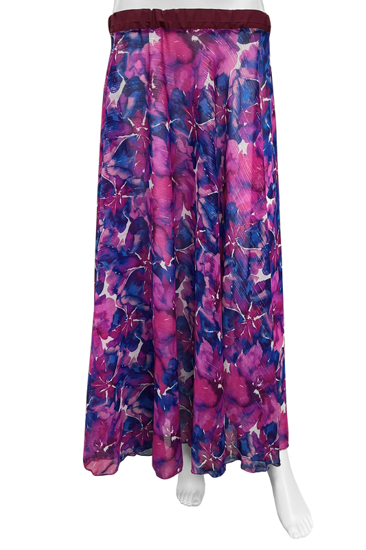 A long skirt with a vibrant floral print in shades of magenta, purple, and blue, featuring a dark burgundy elastic waistband, displayed on a white mannequin against a white background.