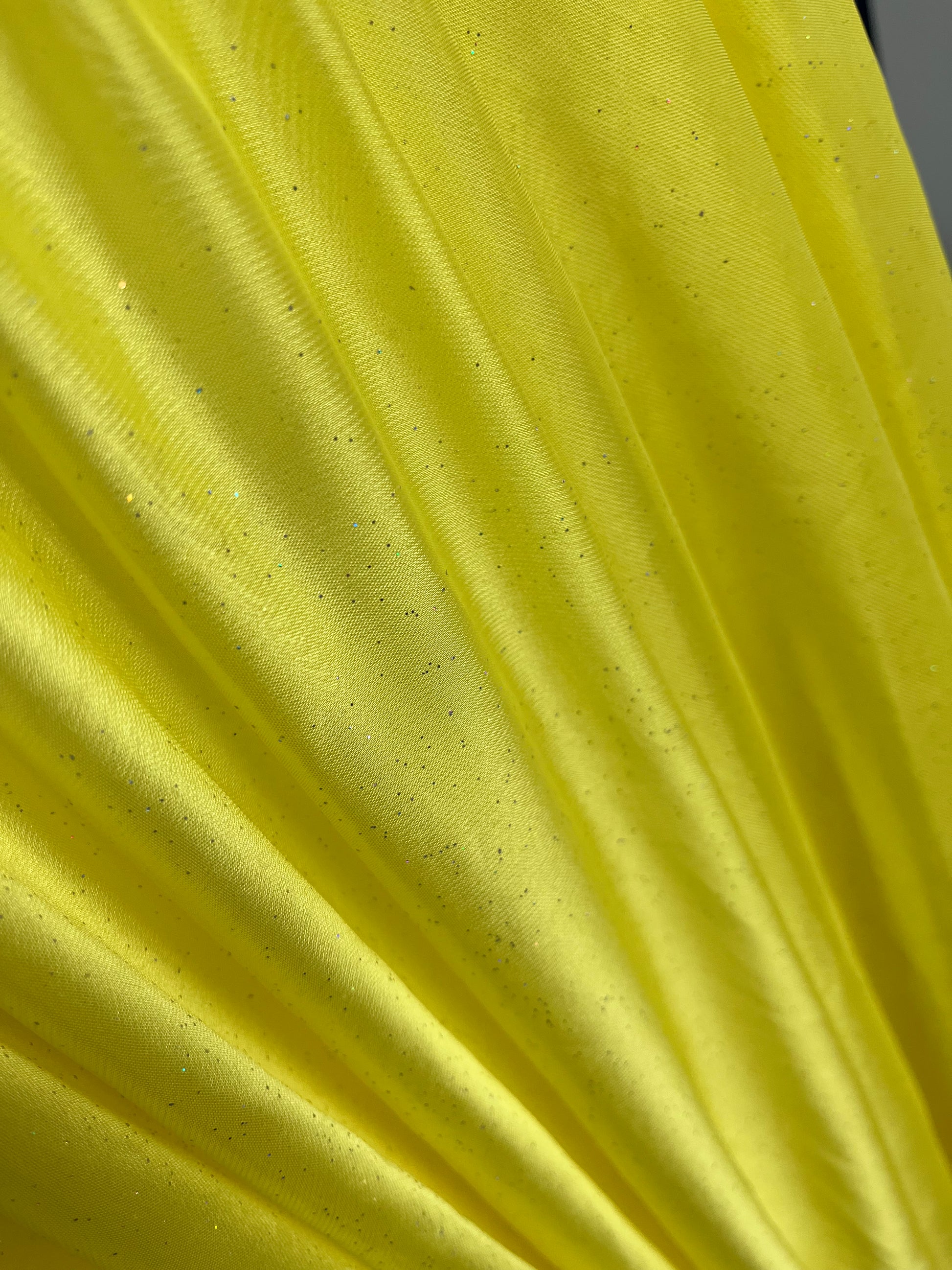 Bright yellow fabric with subtle glitter