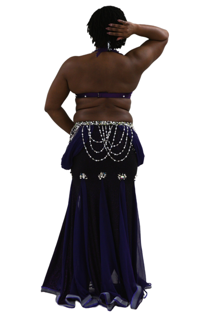 Purple belly dance costume with beaded details on a white background